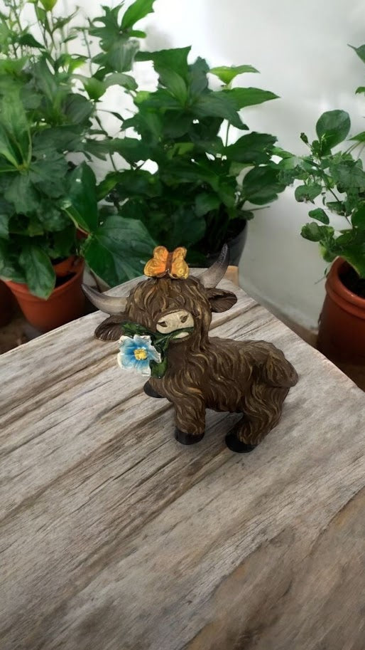 Highland Cow with Blue White Flower